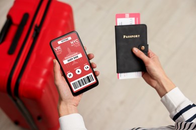 Image of Tourist holding mobile phone with e-ticket for airplane and passport indoors, closeup