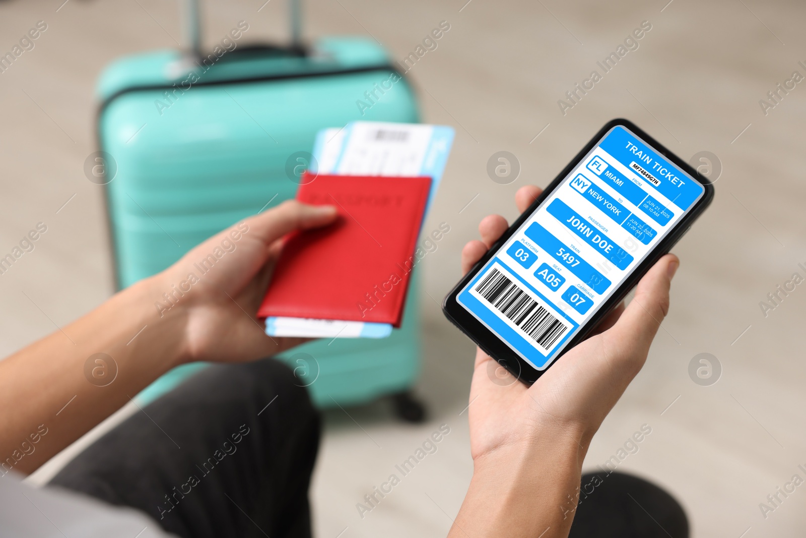 Tourist holding mobile phone with e-ticket for train and passport indoors, closeup Image of Tourist holding mobile phone with e-ticket for train and passport indoors, closeup
