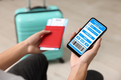 Image of Tourist holding mobile phone with e-ticket for train and passport indoors, closeup