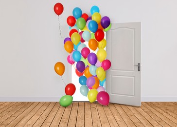Image of Many bright balloons flying into open door. Festive decoration for birthday party or other celebration