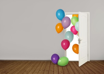 Image of Many bright balloons flying into open door. Festive decoration for birthday party or other celebration