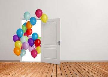Image of Many bright balloons flying into open door. Festive decoration for birthday party or other celebration