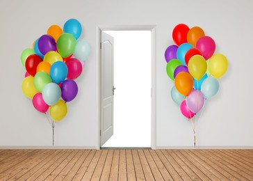 Image of Many bright balloons on either side of open door. Festive decoration for birthday party or other celebration