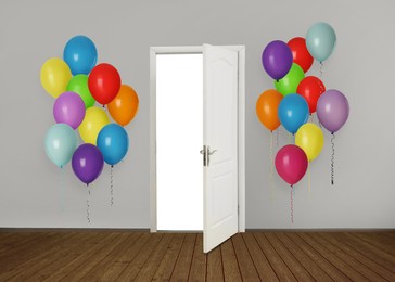 Image of Many bright balloons on either side of open door. Festive decoration for birthday party or other celebration