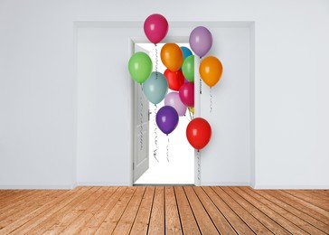 Image of Many bright balloons flying into open door. Festive decoration for birthday party or other celebration