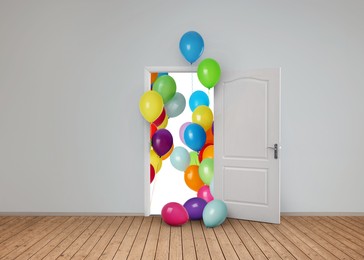 Image of Many bright balloons flying into open door. Festive decoration for birthday party or other celebration