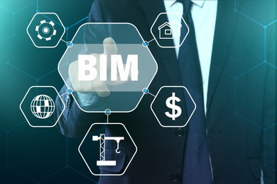 Image of Building information modeling. Man using virtual screen with abbreviation BIM and different icons, closeup