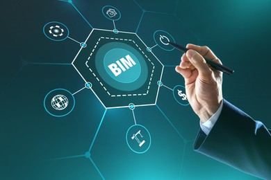 Image of Building information modeling. Man using virtual screen with abbreviation BIM and different icons, closeup
