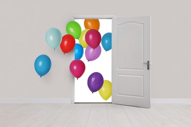 Image of Many bright balloons flying into open door. Festive decoration for birthday party or other celebration