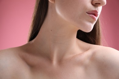 Photo of Woman with beautiful collarbones and neck on pink background, closeup