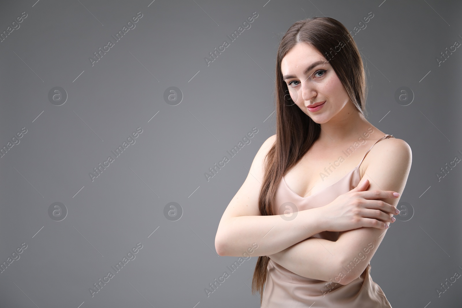 Portrait of beautiful woman on grey background. Space for text Photo of Portrait of beautiful woman on grey background. Space for text