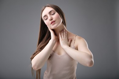 Photo of Portrait of beautiful woman on grey background