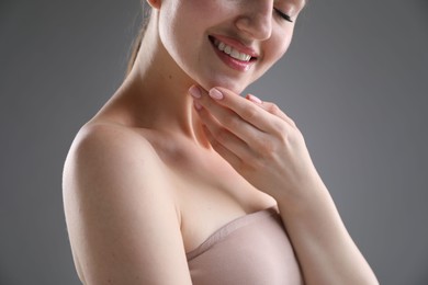 Photo of Attractive woman against grey background, closeup on shoulder