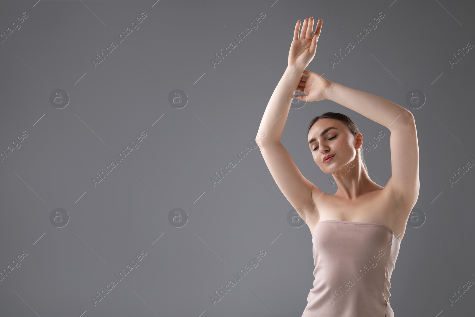 Portrait of beautiful woman on grey background. Space for text Photo of Portrait of beautiful woman on grey background. Space for text