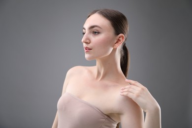 Photo of Portrait of beautiful woman on grey background. Space for text