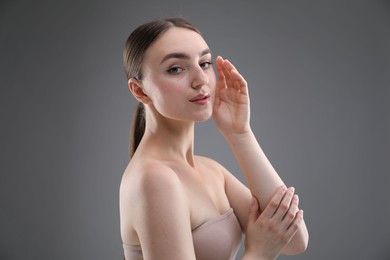 Photo of Portrait of beautiful woman on grey background