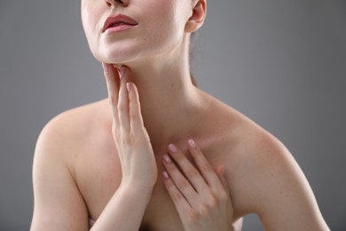 Photo of Woman with beautiful collarbones and neck on grey background, closeup