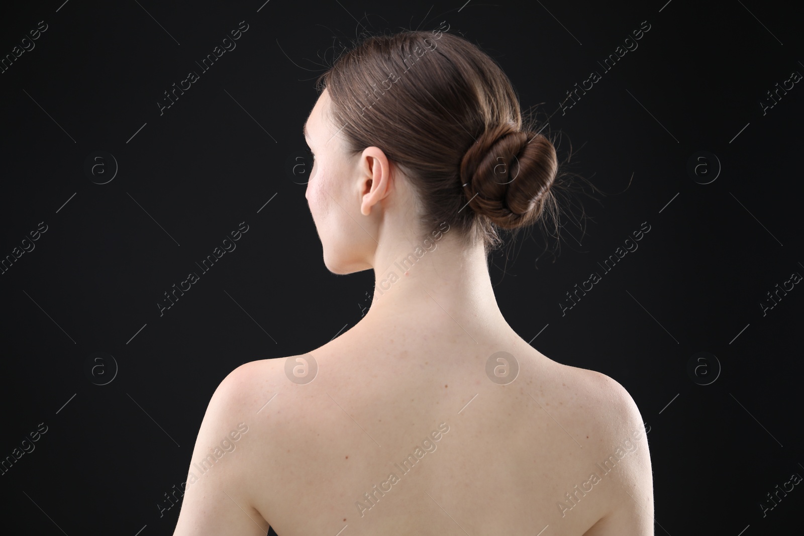 Beautiful woman on black background, back view Photo of Beautiful woman on black background, back view