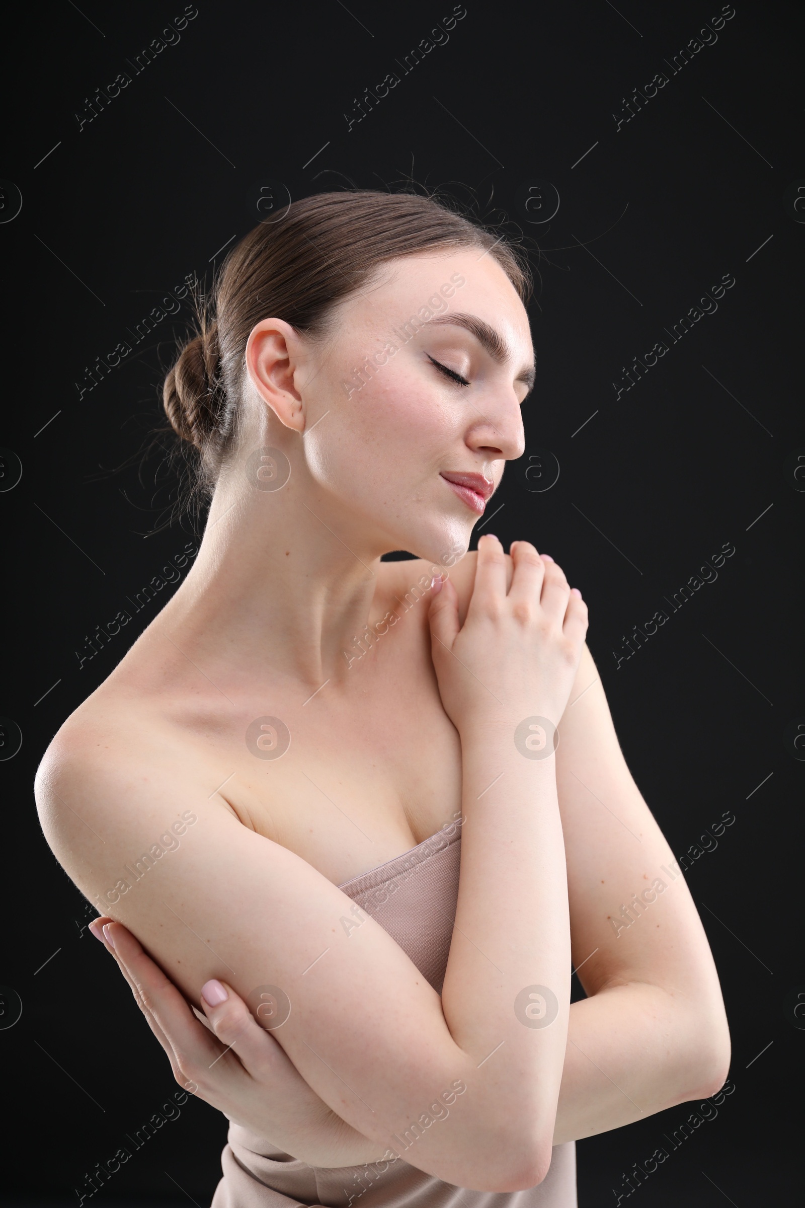 Portrait of beautiful woman on black background Photo of Portrait of beautiful woman on black background