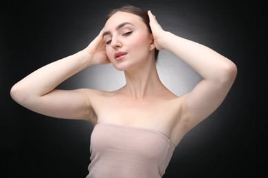Photo of Portrait of beautiful woman on black background