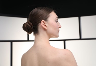 Photo of Beautiful woman on light background, back view