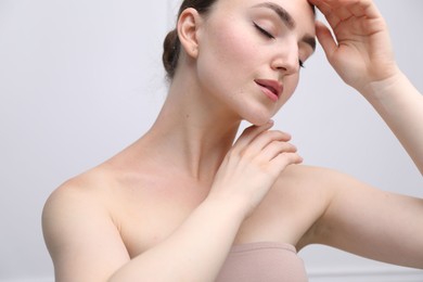 Photo of Woman with beautiful collarbones and neck on light background, closeup