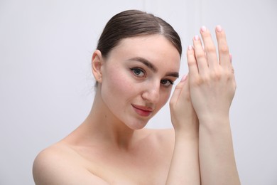 Photo of Portrait of beautiful woman on light background