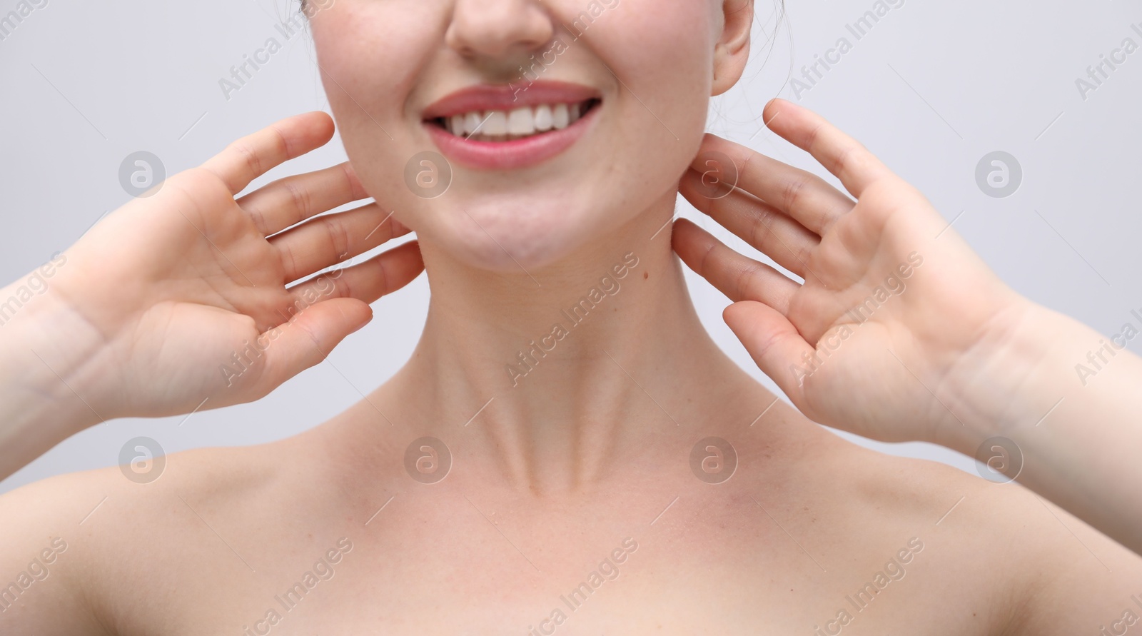 Woman with beautiful collarbones and neck on light background, closeup Photo of Woman with beautiful collarbones and neck on light background, closeup