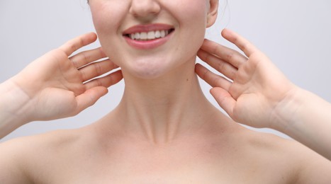 Photo of Woman with beautiful collarbones and neck on light background, closeup
