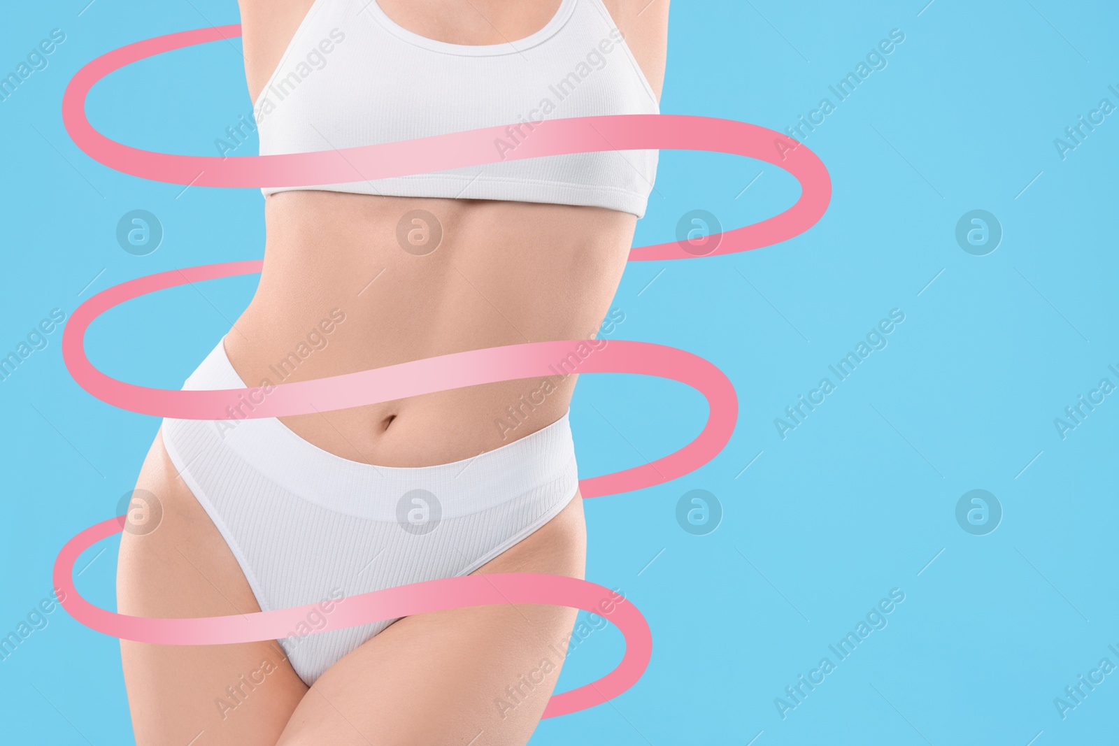 Beautiful woman with perfect figure on light blue background, closeup. Ribbon around her body. Result of healthy lifestyle, diet, sport trainings Image of Beautiful woman with perfect figure on light blue background, closeup. Ribbon around her body. Result of healthy lifestyle, diet, sport trainings