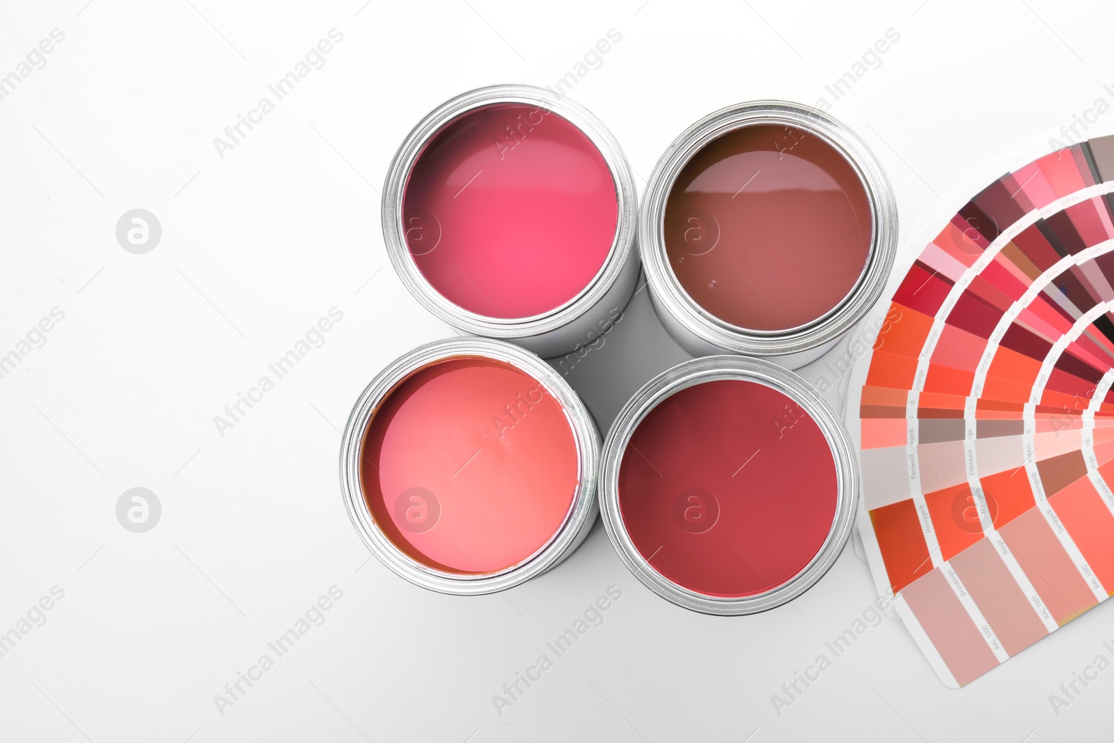 Cans with paint in different shades and color palette on white background, top view Image of Cans with paint in different shades and color palette on white background, top view