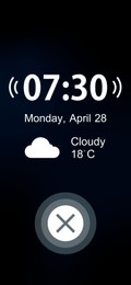 Image of Alarm clock app for mobile phone. Interface with set time, weekday, date, weather conditions and off button