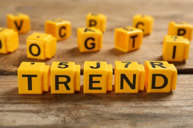 Image of Word Trend made of yellow cubes with letters on wooden table