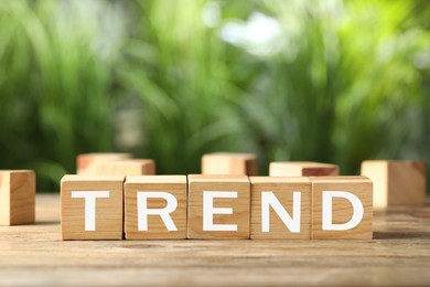 Image of Word Trend made of wooden cubes with letters on table outdoors