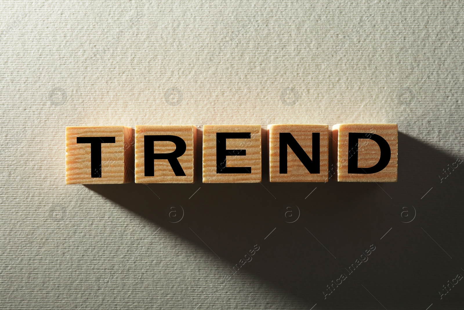 Word Trend made of wooden cubes with letters on white textured background, top view Image of Word Trend made of wooden cubes with letters on white textured background, top view