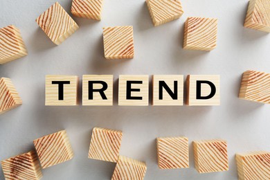 Image of Word Trend made of wooden cubes with letters on white background, top view