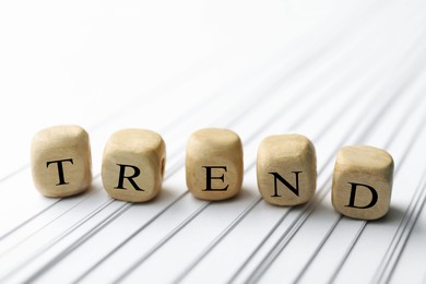 Image of Word Trend made of wooden cubes with letters on sheets of paper