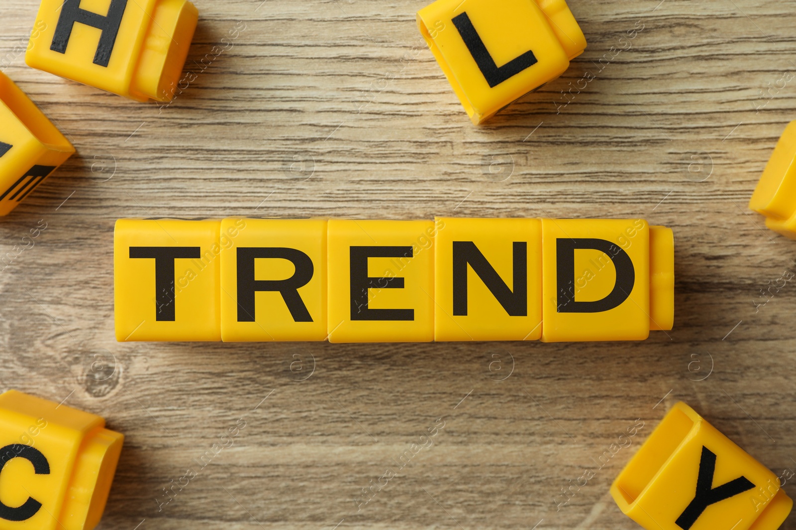 Word Trend made of yellow cubes with letters on wooden background, top view Image of Word Trend made of yellow cubes with letters on wooden background, top view
