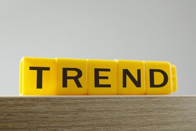 Image of Word Trend made of yellow cubes with letters on table