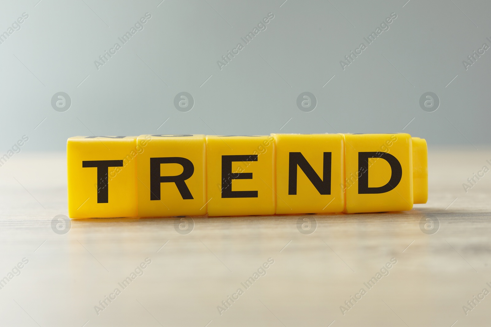 Word Trend made of yellow cubes with letters on table Image of Word Trend made of yellow cubes with letters on table