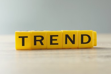 Image of Word Trend made of yellow cubes with letters on table