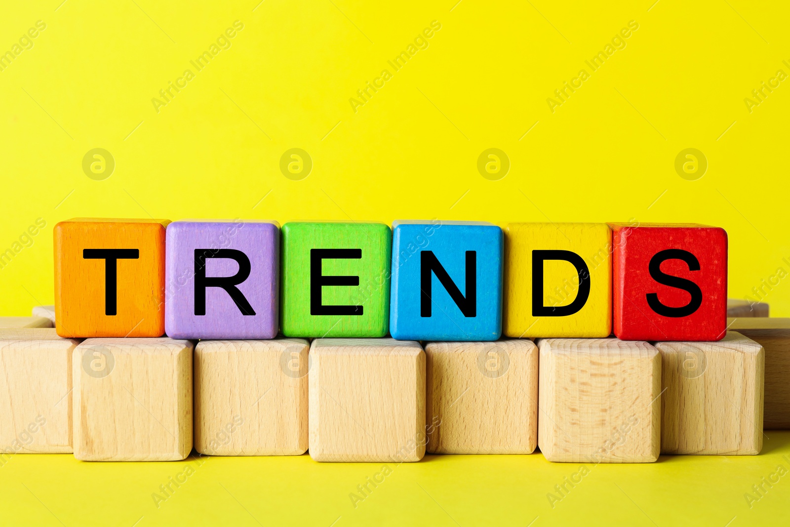 Word Trends made of colorful cubes with letters on yellow background Image of Word Trends made of colorful cubes with letters on yellow background