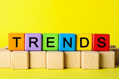 Image of Word Trends made of colorful cubes with letters on yellow background