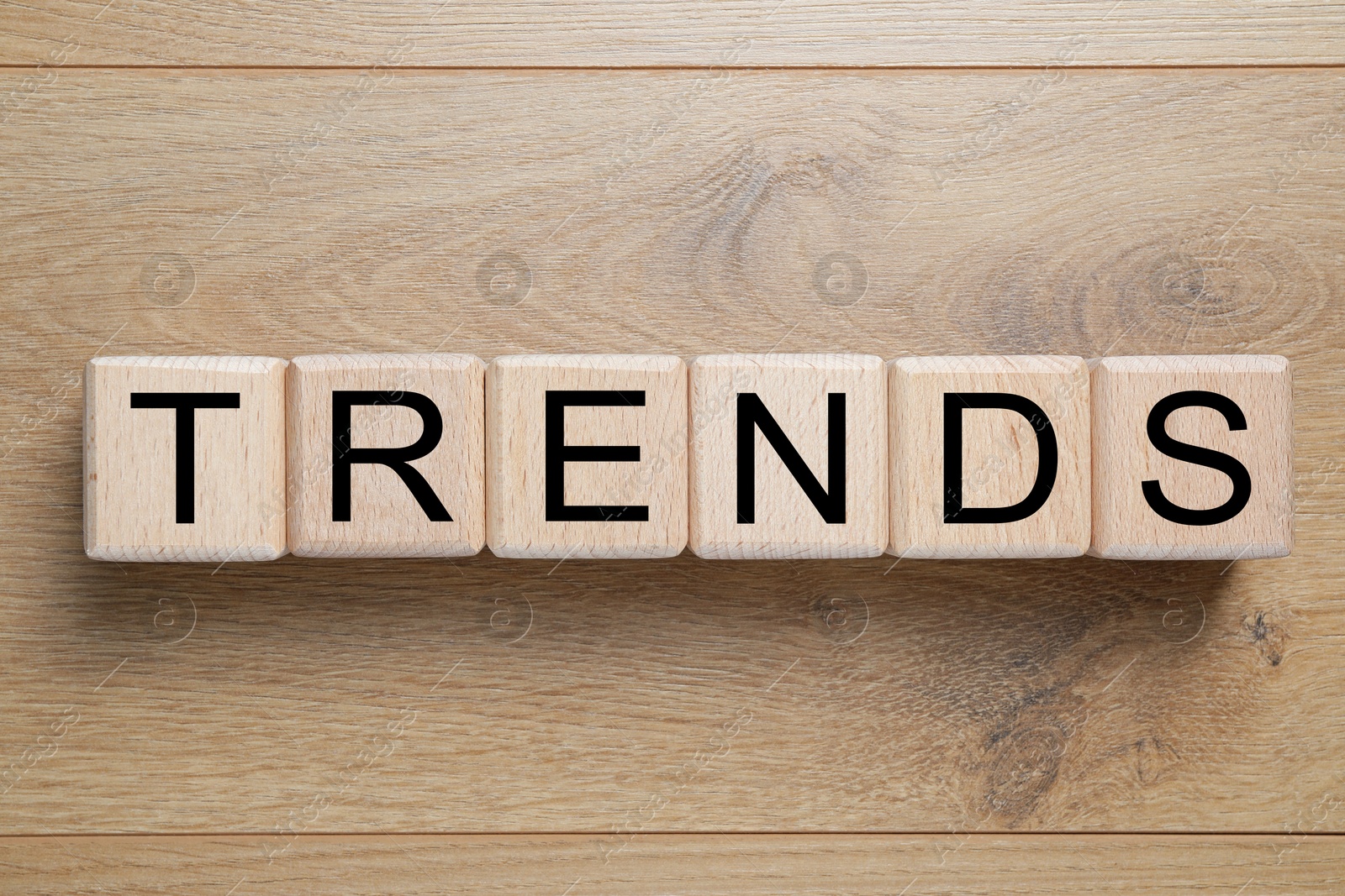 Word Trends made of cubes with letters on wooden background, top view Image of Word Trends made of cubes with letters on wooden background, top view