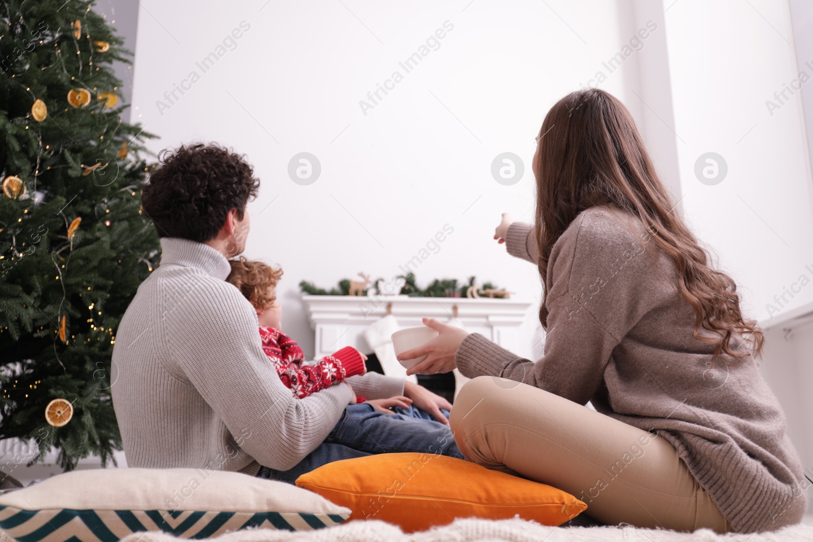 Family watching movie via video projector at home Photo of Family watching movie via video projector at home