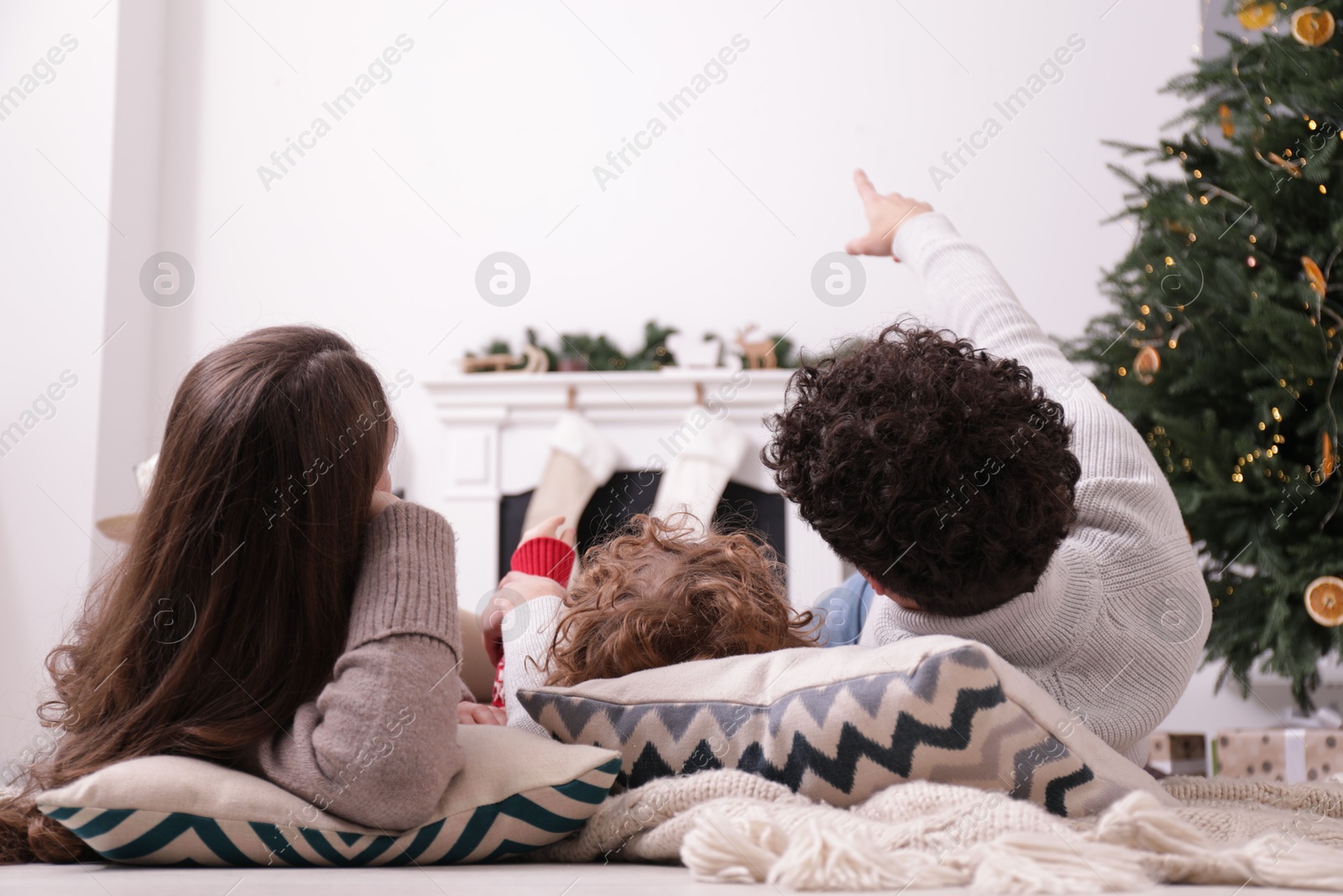 Family watching movie via video projector at home, back view Photo of Family watching movie via video projector at home, back view