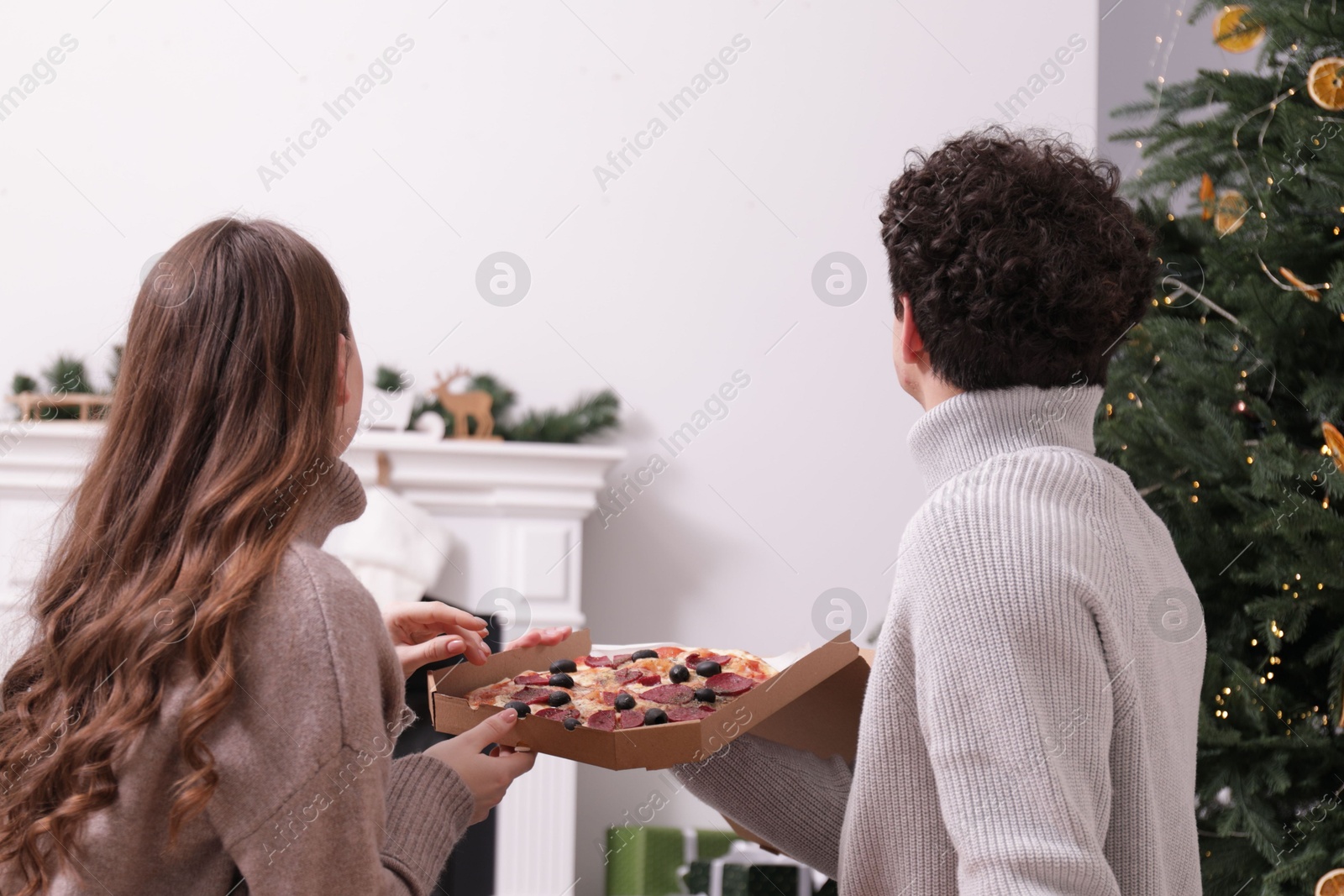 Couple with pizza watching movie via video projector at home Photo of Couple with pizza watching movie via video projector at home