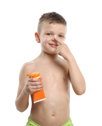 Photo of Little boy with tube applying sun protection cream onto his skin on white background