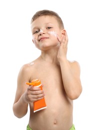 Photo of Little boy with tube applying sun protection cream onto his skin on white background