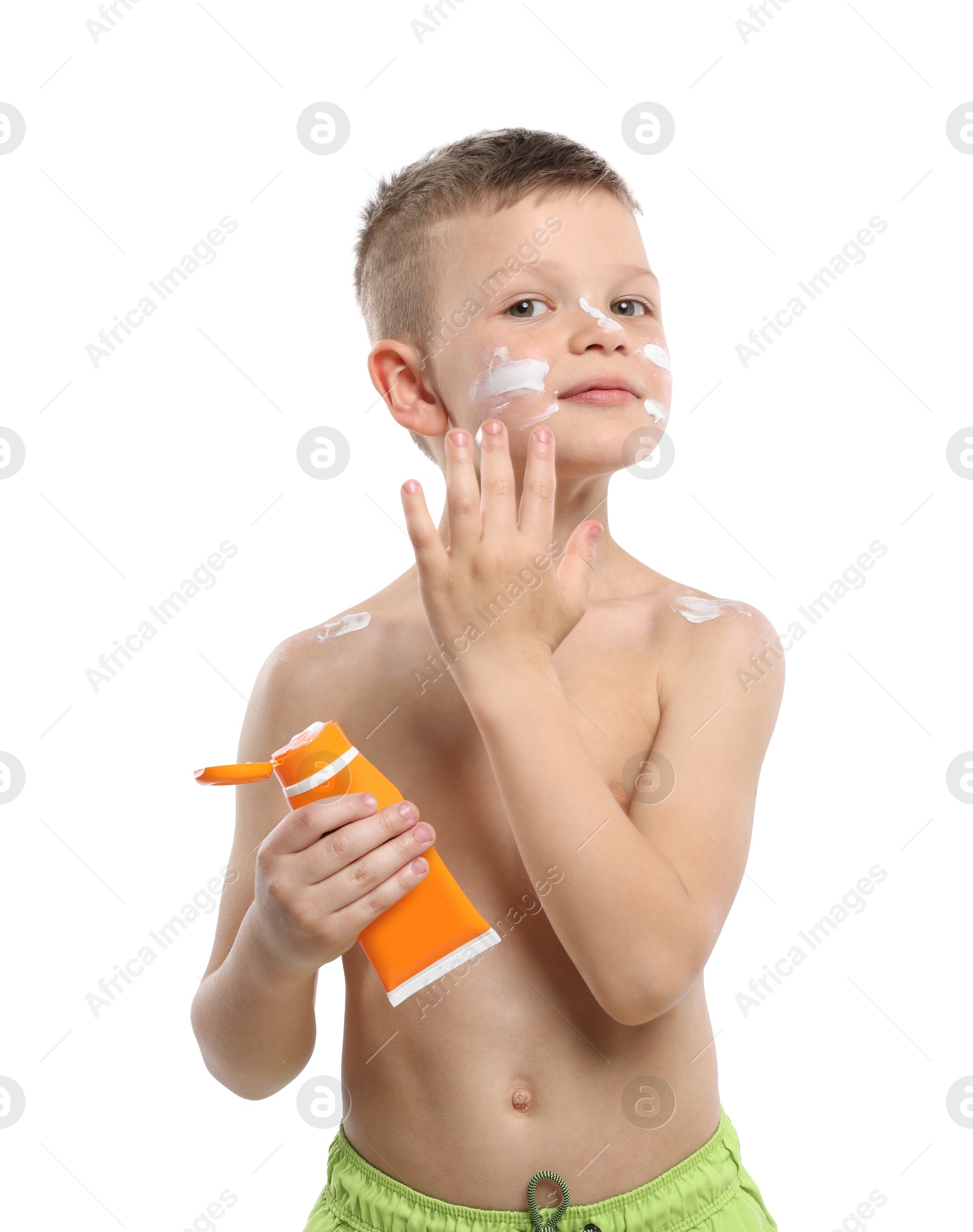 Little boy with tube applying sun protection cream onto his skin on white background Photo of Little boy with tube applying sun protection cream onto his skin on white background